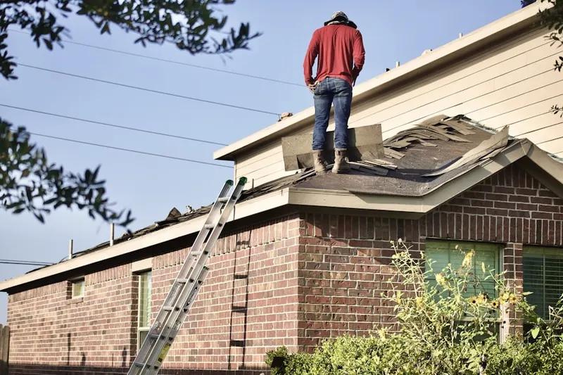 Professional roofer working on a residential roof in Kings Crossroads